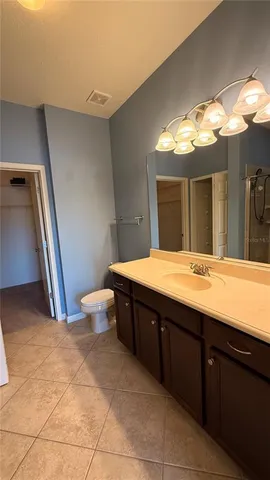 a bathroom with a sink mirror vanity and toilet
