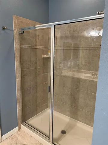 a bathroom with a glass shower door