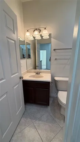 a bathroom with a sink a toilet and mirror