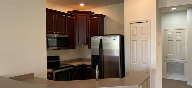 a kitchen with metallic refrigerator freezer and a dishwasher