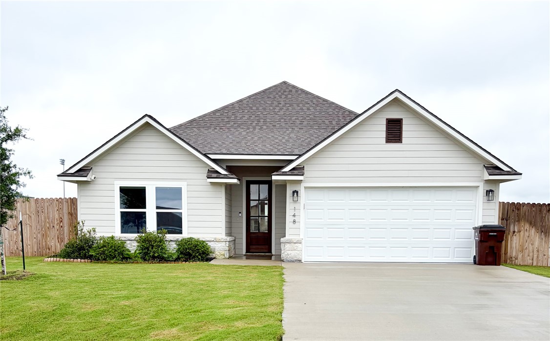 148 Turnrow Cove Somerville, TX 77879 - Photo 1 of 32 a front view of house with yard and garage