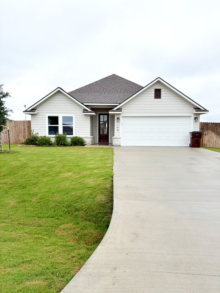 148 Turnrow Cove Somerville, TX 77879 - Photo 2 of 32 a view of a house with a yard