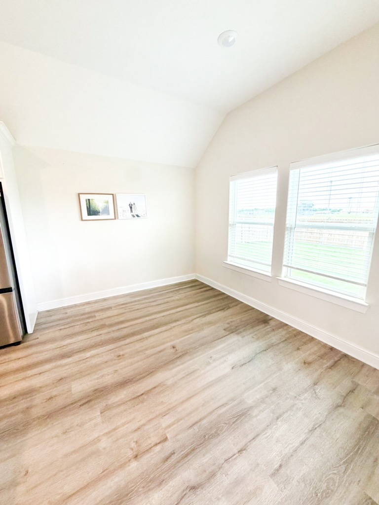 148 Turnrow Cove Somerville, TX 77879 - Photo 21 of 32 an empty room with wooden floor and windows