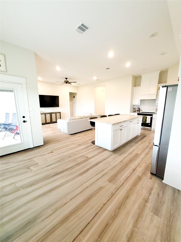 148 Turnrow Cove Somerville, TX 77879 - Photo 6 of 32 a large room with stainless steel appliances wooden floor and view living room