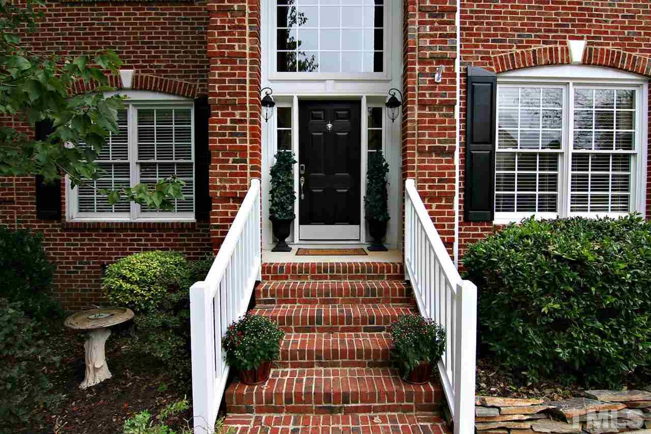 4109 Batiste Road Raleigh, NC 27613 - Photo 2 of 25 a view of a brick house with plants and entryway
