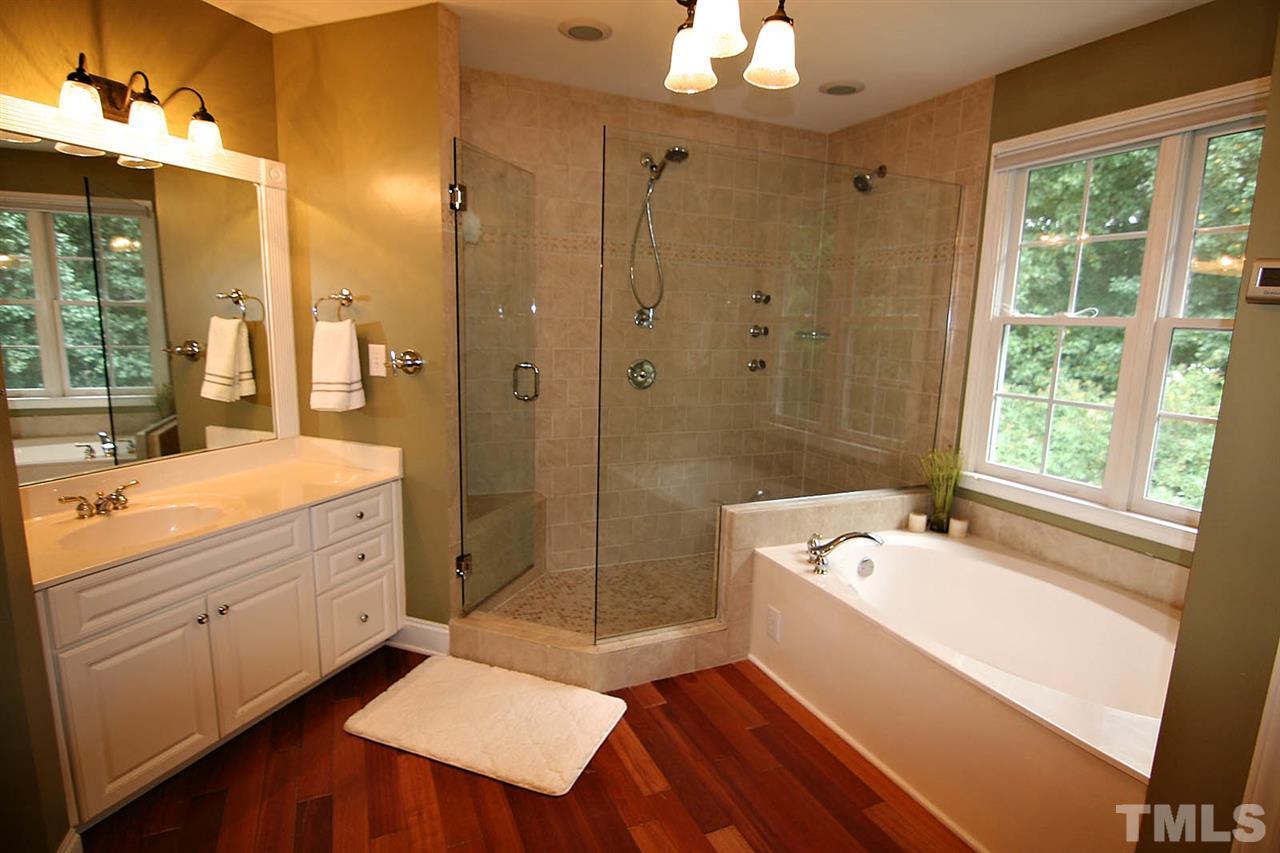 4109 Batiste Road Raleigh, NC 27613 - Photo 16 of 25 a bathroom with a tub sink shower and two mirror