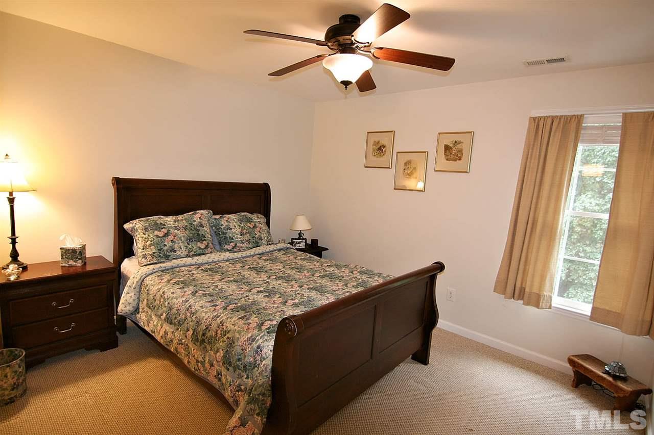 4109 Batiste Road Raleigh, NC 27613 - Photo 18 of 25 a bedroom with a bed dresser and a window