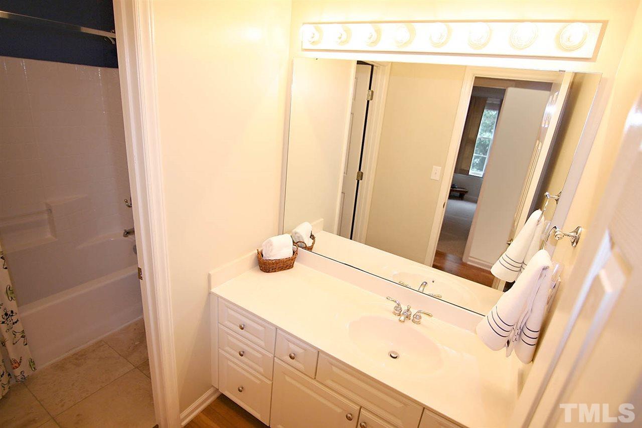 4109 Batiste Road Raleigh, NC 27613 - Photo 19 of 25 a bathroom with a sink and a mirror
