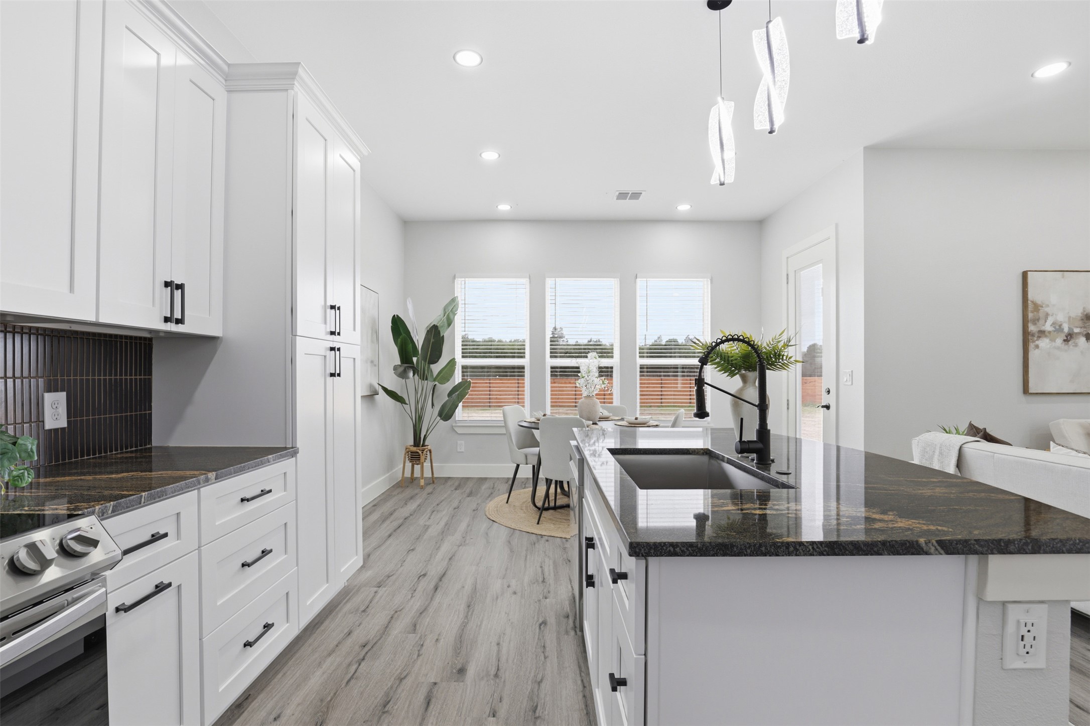 113 Los Robles Road Elgin, TX 78621 - Photo 4 of 20 Kitchen island with dark countertop and undermount sink