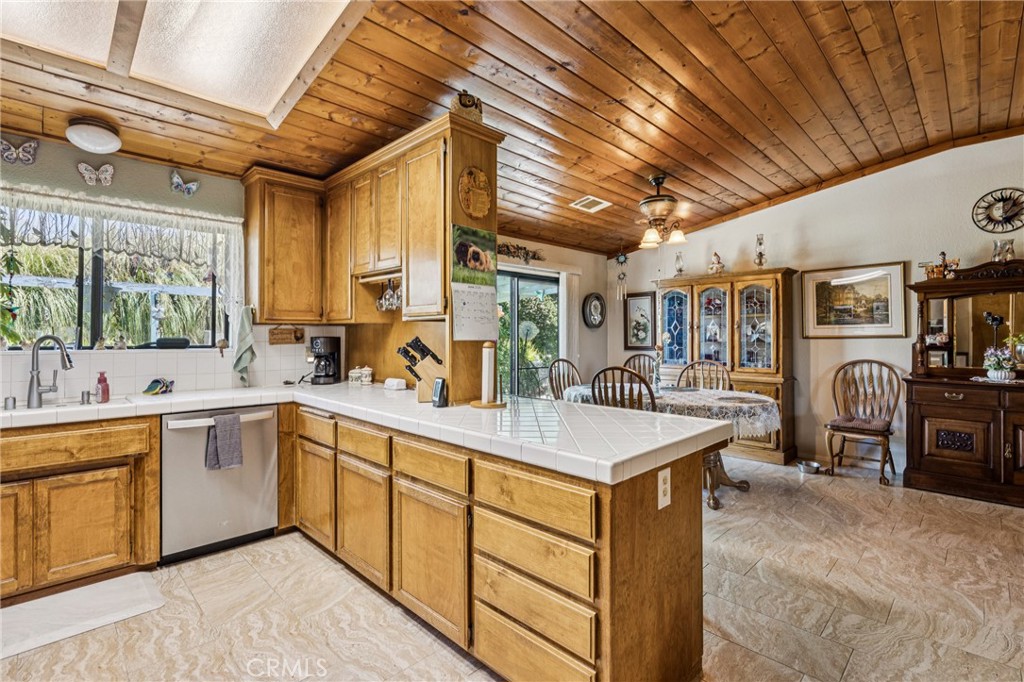 7050 Shale Rock Road Paso Robles, CA 93446 - Photo 12 of 45 a large kitchen with stainless steel appliances granite countertop a sink window and cabinets