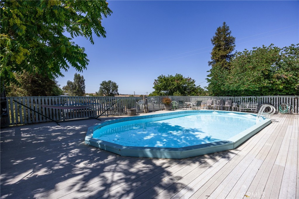 7050 Shale Rock Road Paso Robles, CA 93446 - Photo 37 of 45 a view of a swimming pool with a yard and plants