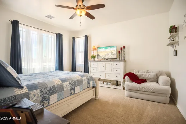 a bedroom with a bed couch and window