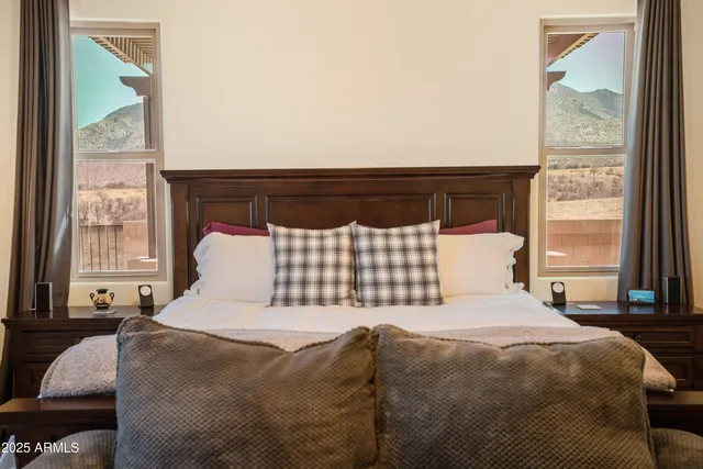 a large bed sitting in a bedroom next to a window