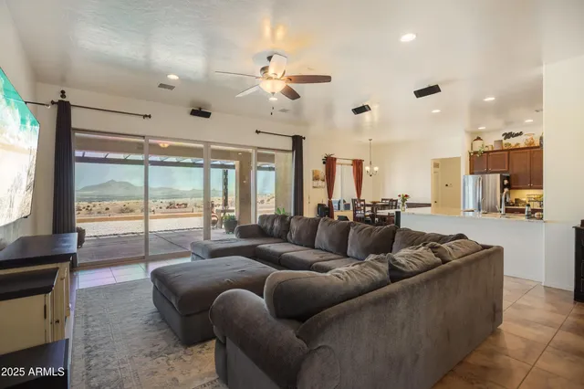 a living room with furniture a large window and a flat screen tv