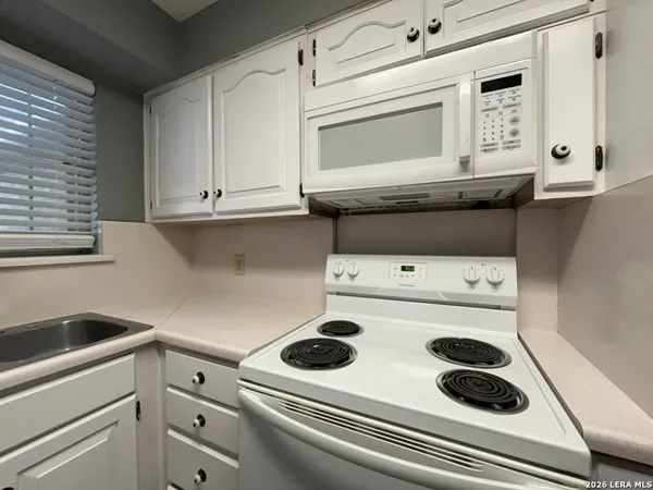 a kitchen with a stove and a microwave