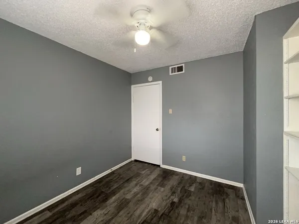 a view of an empty room and a window