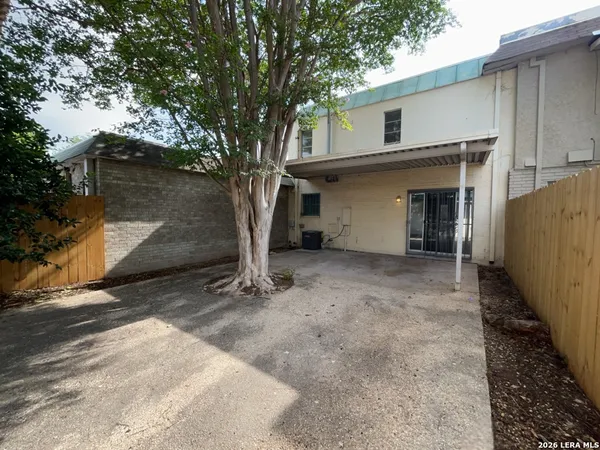 a view of a backyard with a large tree