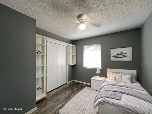 a bedroom with a large bed and a chandelier