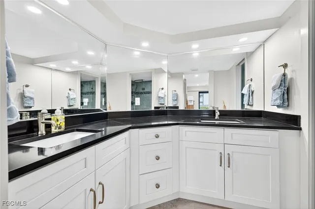 a large white kitchen with granite countertop white cabinets and a granite counter tops