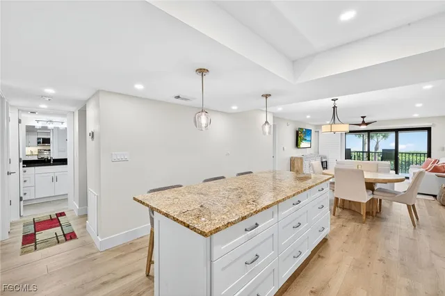 a living room with kitchen island furniture and a wooden floor