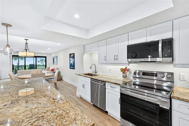 a kitchen with stainless steel appliances a stove sink and cabinets