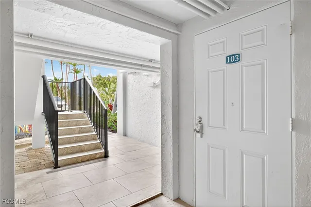 a view of entryway with stairs and wooden floor