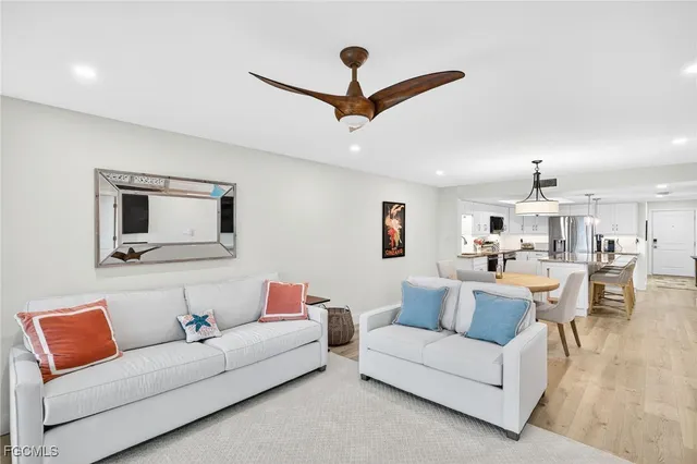 a living room with furniture and a ceiling fan