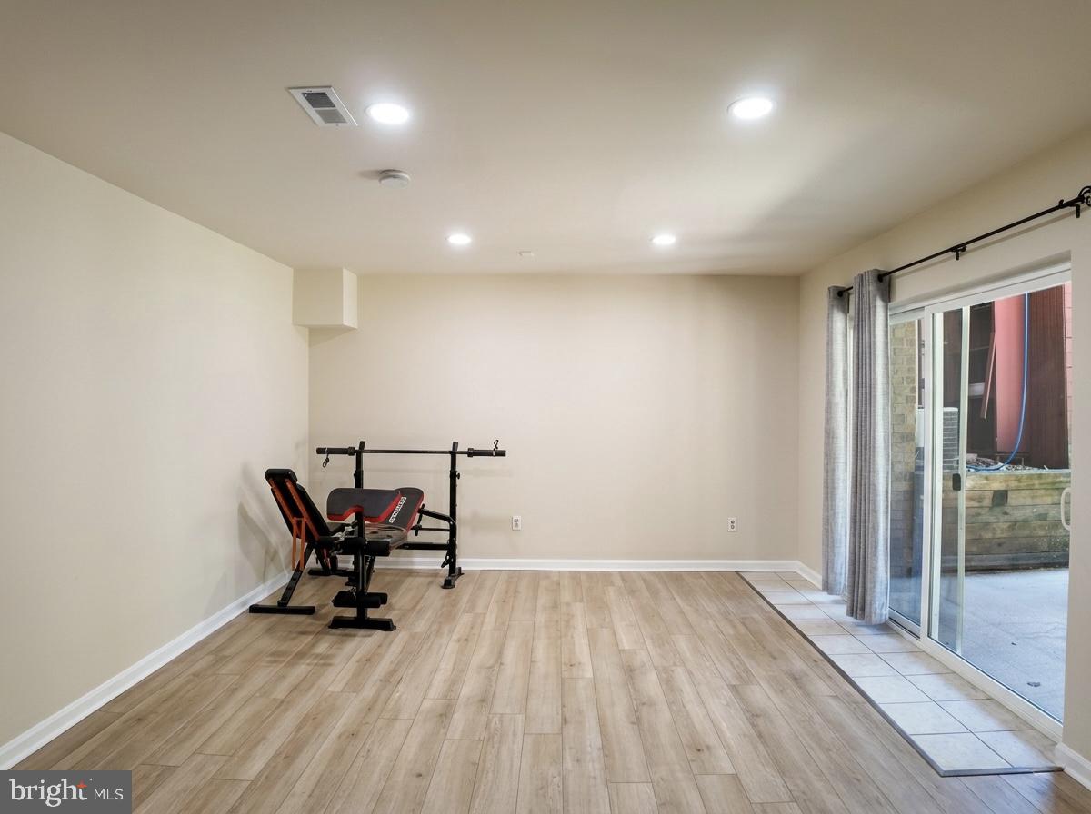 3614 Fawn Spring Court Baltimore, MD 21234 - Photo 5 of 22 an empty room with wooden floor and chairs