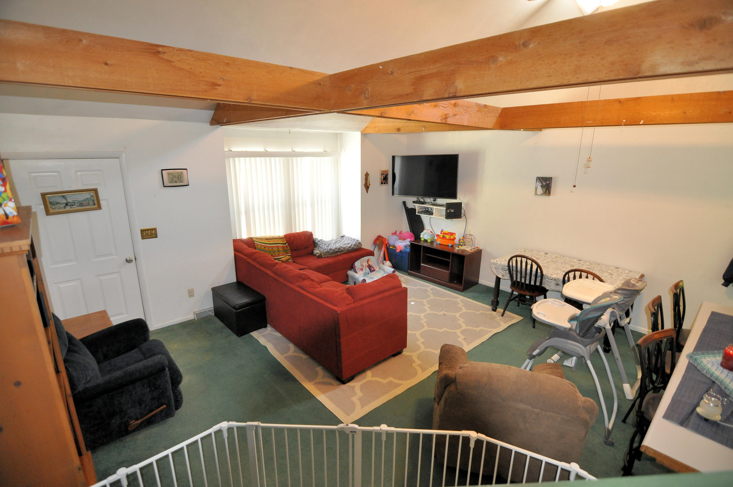 570 Zimmerman Road Blue Ridge, VA 24064 - Photo 12 of 24 a living room with furniture a flat screen tv and a window