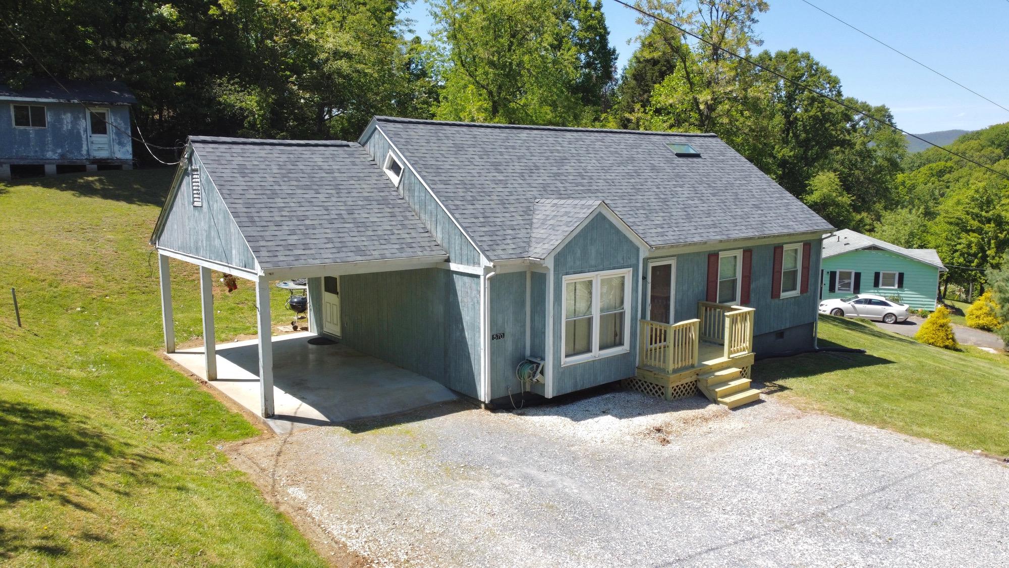570 Zimmerman Road Blue Ridge, VA 24064 - Photo 3 of 24 a view of a house with a yard and large tree