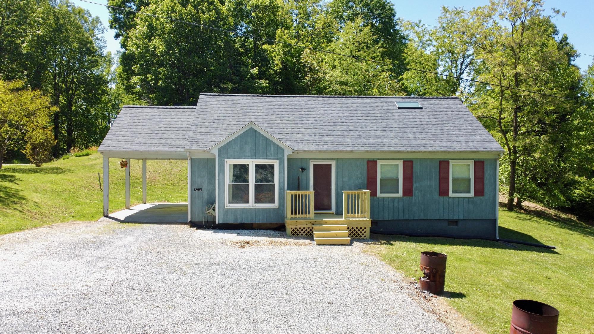 570 Zimmerman Road Blue Ridge, VA 24064 - Photo 4 of 24 a front view of a house with a yard and garage