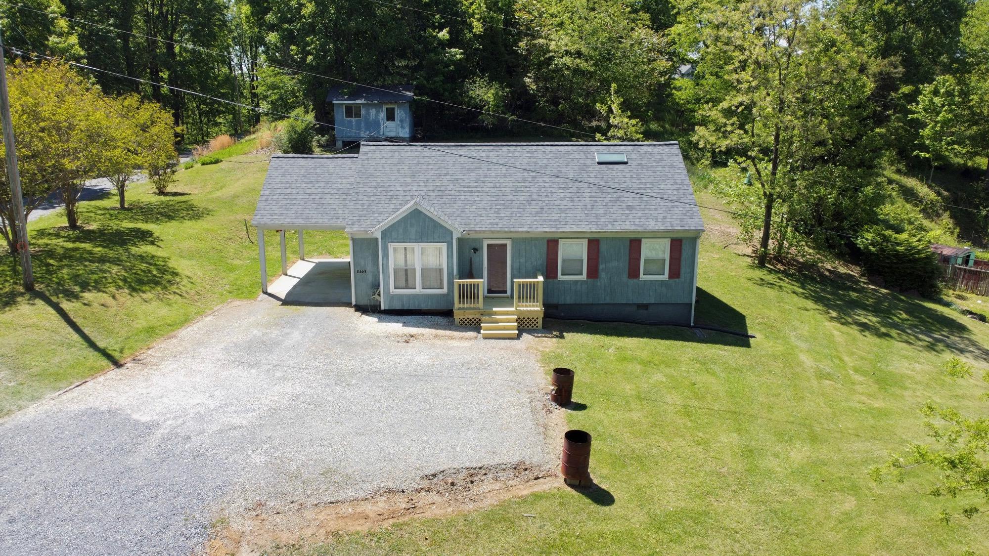 570 Zimmerman Road Blue Ridge, VA 24064 - Photo 7 of 24 a front view of a house with a yard and garage