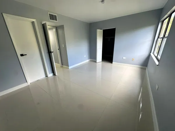 wooden floor in an empty room with a mirror