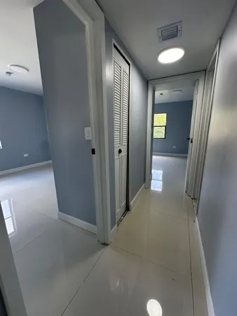 an empty room with mirror and entrance