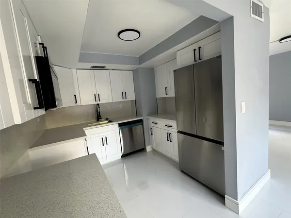 a kitchen with a refrigerator a sink and a stove