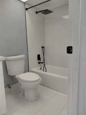a bathroom with a toilet and a tub