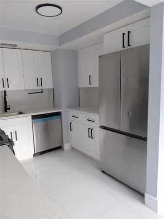 a kitchen with cabinets and white appliances