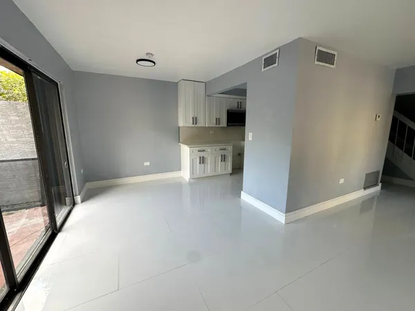 a view of a kitchen with a sink and a refrigerator