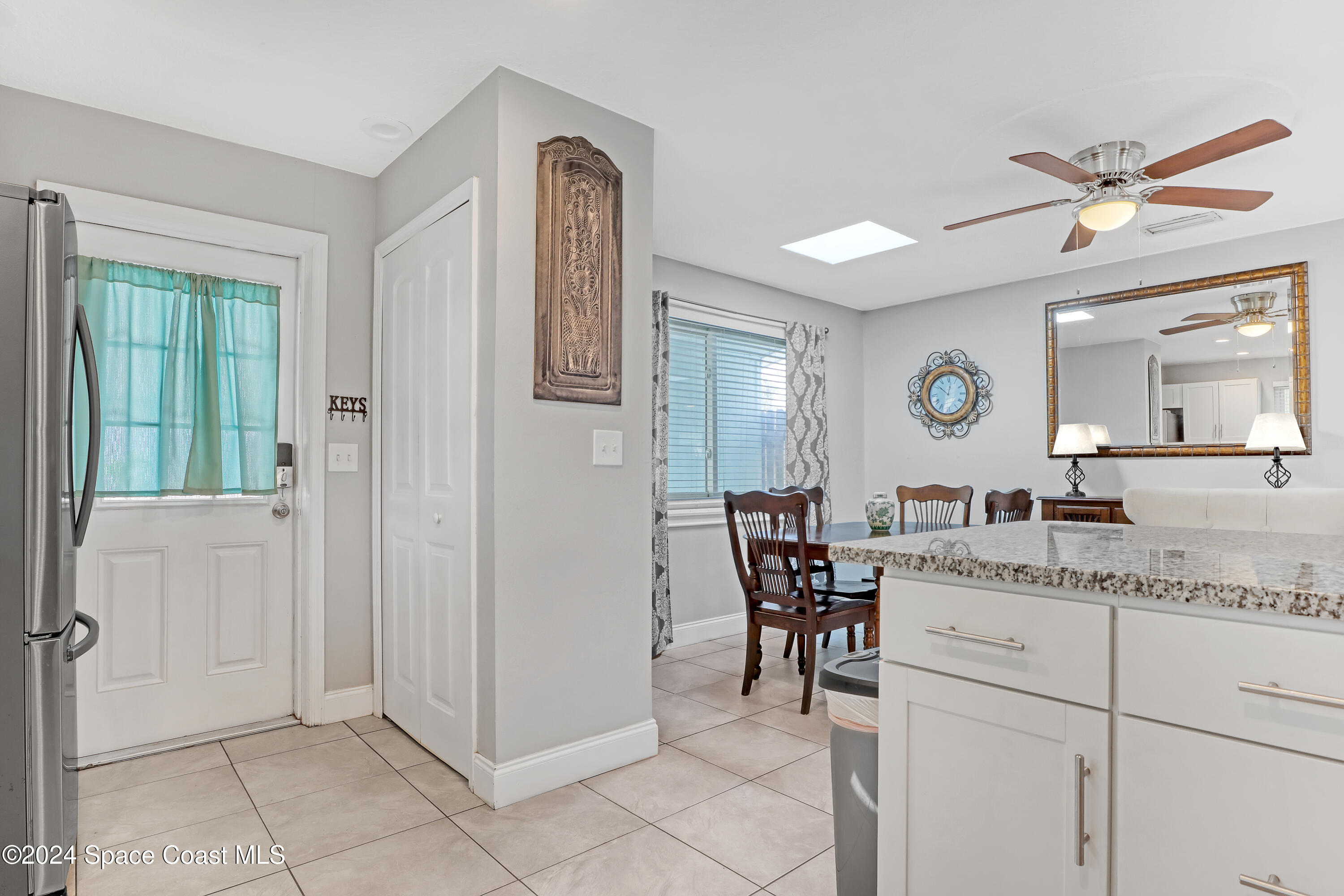 2581 Locksley Road Melbourne, FL 32935 - Photo 15 of 33 a view of a hallway that has a dining table and chairs
