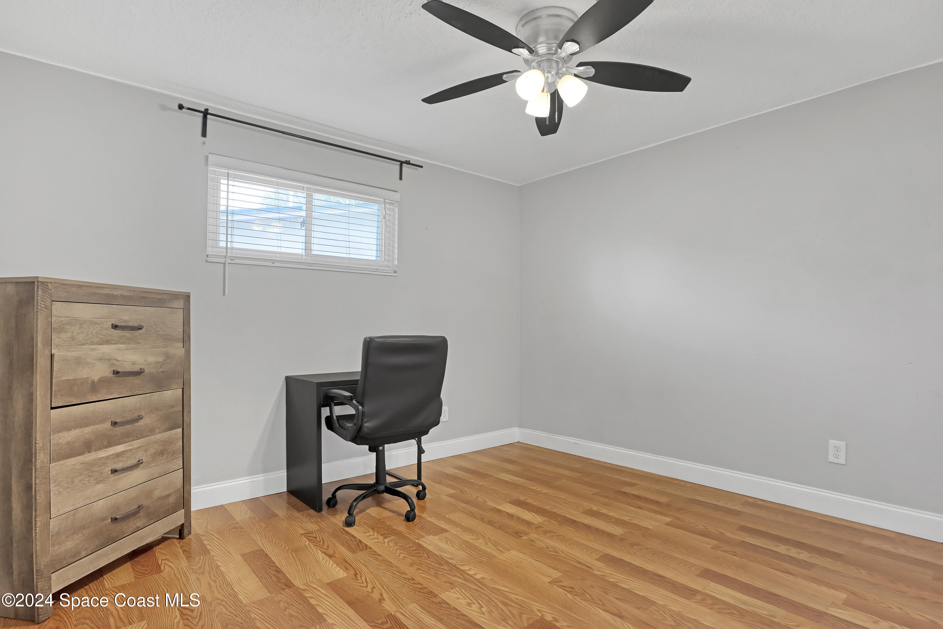 2581 Locksley Road Melbourne, FL 32935 - Photo 25 of 33 a view of a workspace with furniture and a window