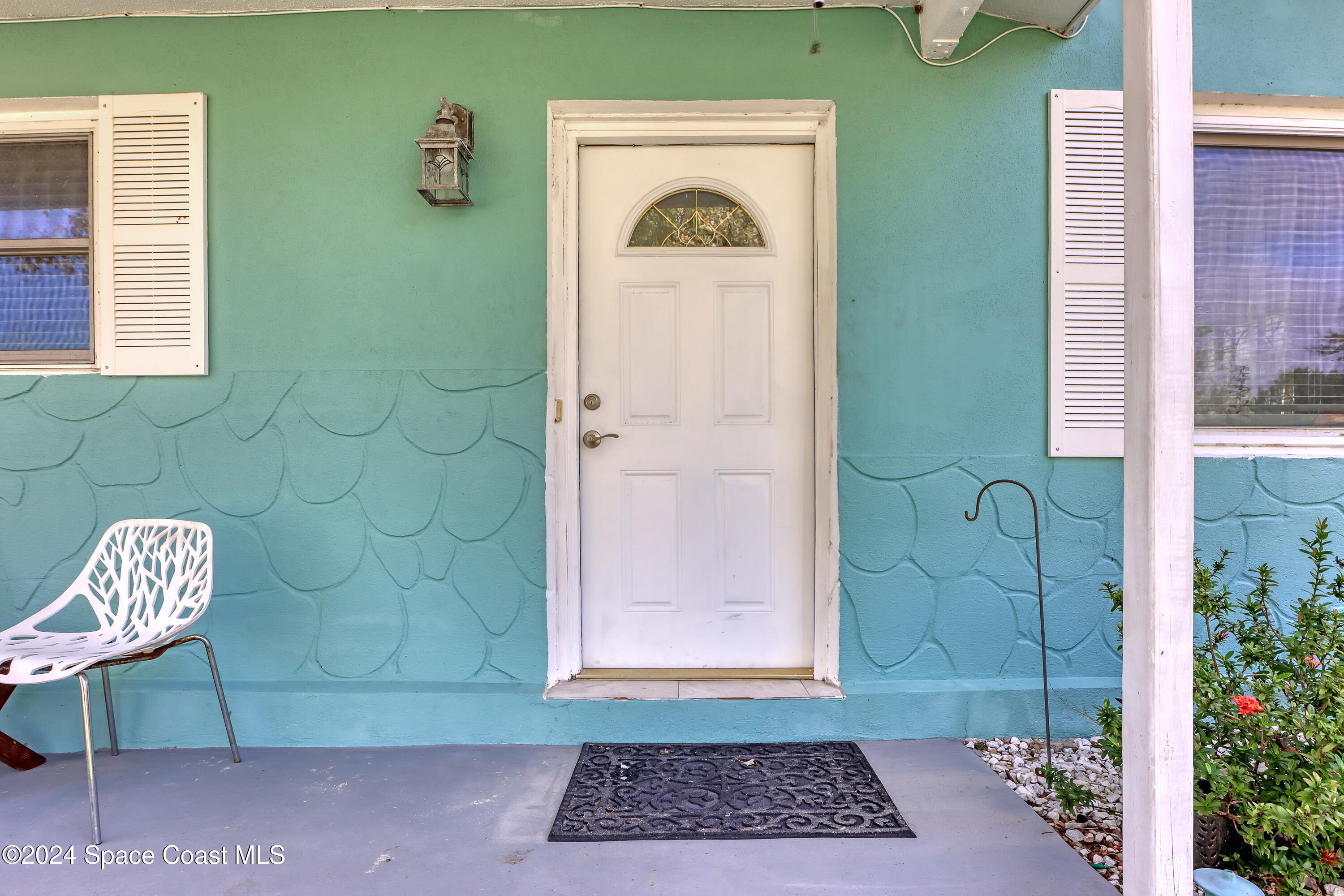 2581 Locksley Road Melbourne, FL 32935 - Photo 5 of 33 a view of that has two chairs and a window with wooden floor