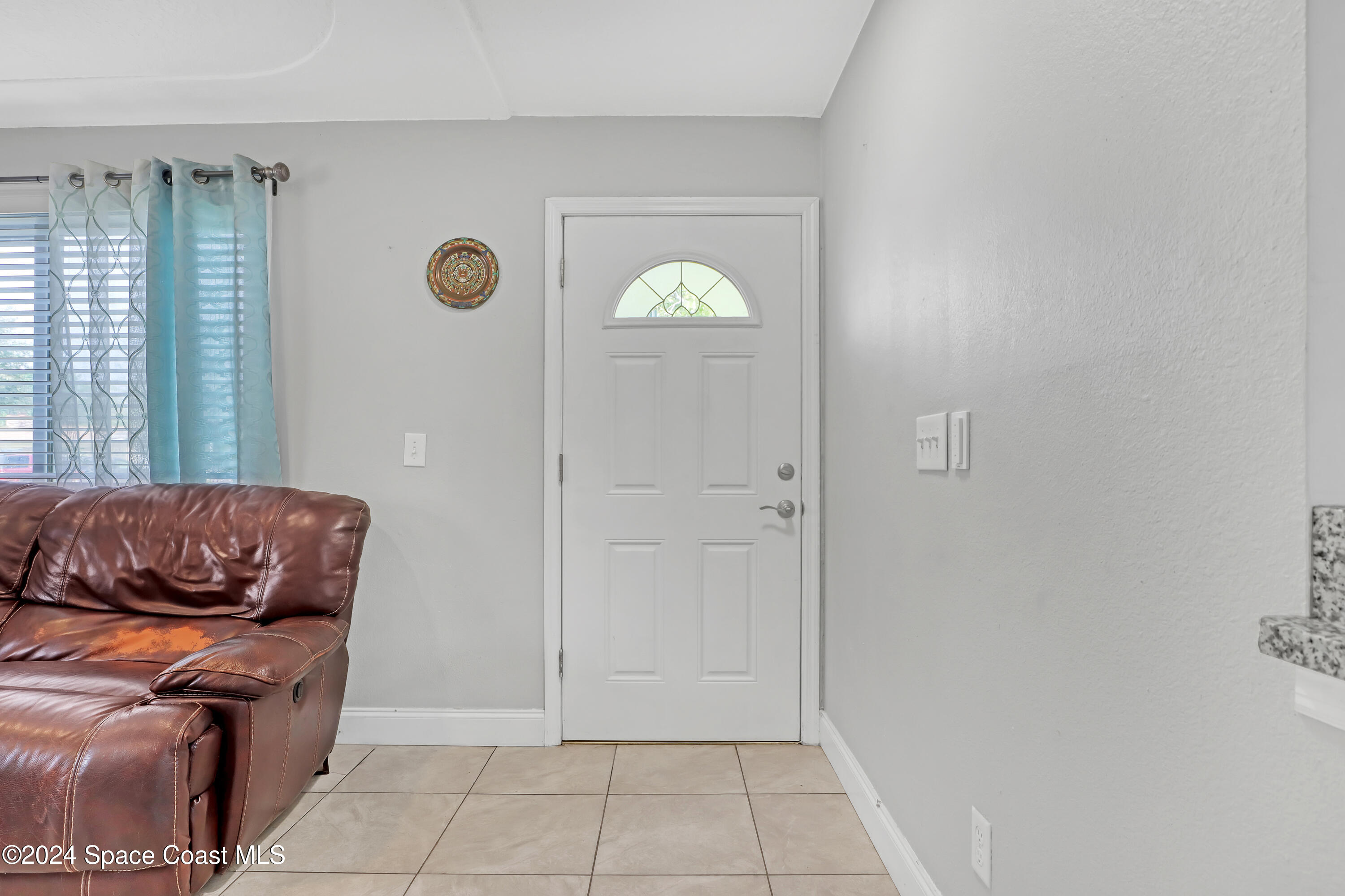 2581 Locksley Road Melbourne, FL 32935 - Photo 6 of 33 a living room with furniture and a window