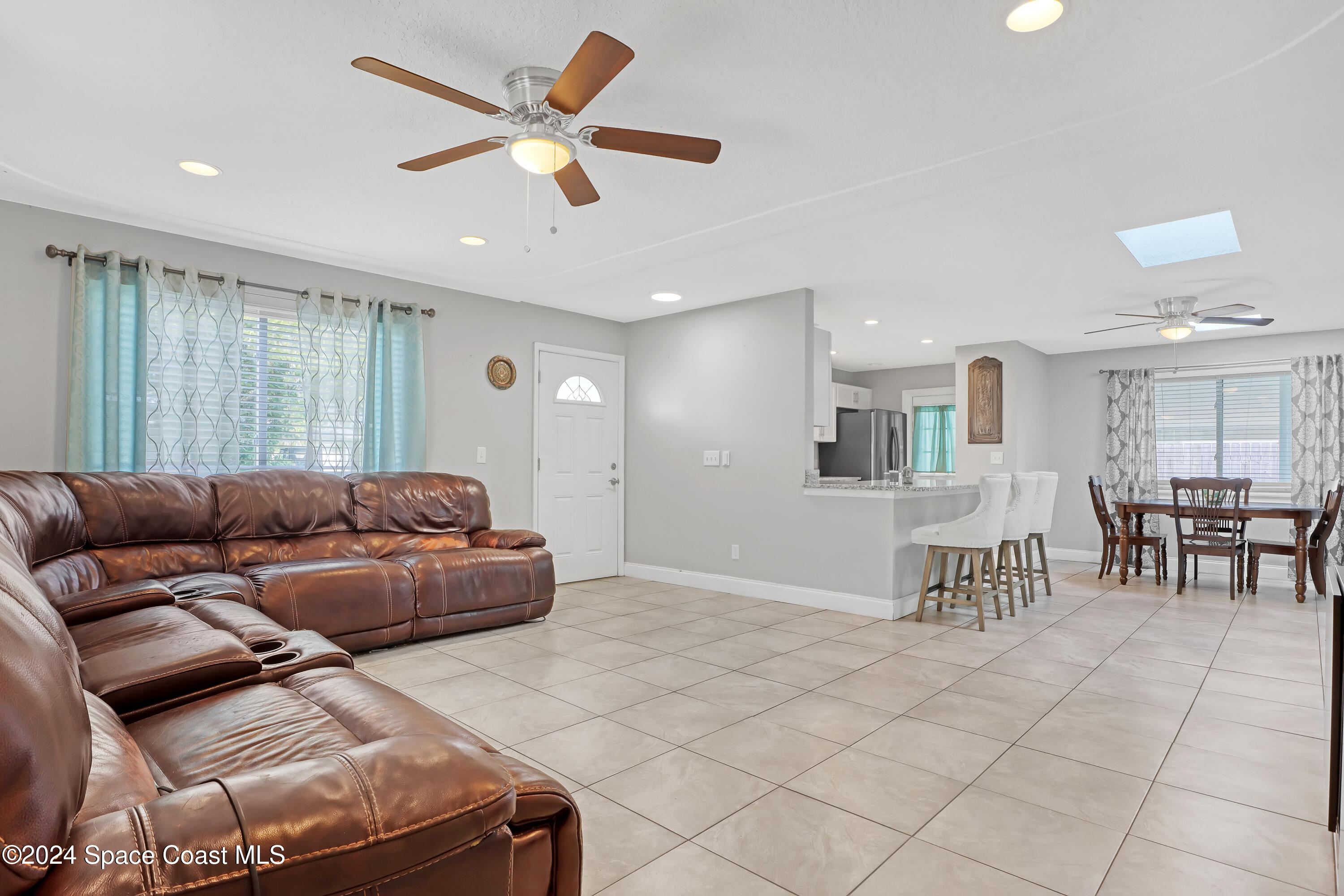 2581 Locksley Road Melbourne, FL 32935 - Photo 9 of 33 a living room with furniture and kitchen view