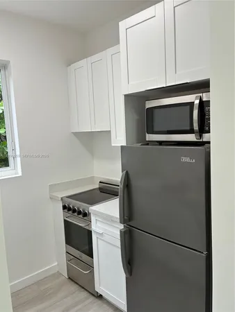 a kitchen with appliances and cabinets