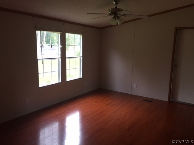 2012 Trivette Road Beaverdam, VA 23015 - Photo 3 of 11 an empty room with wooden floor and windows