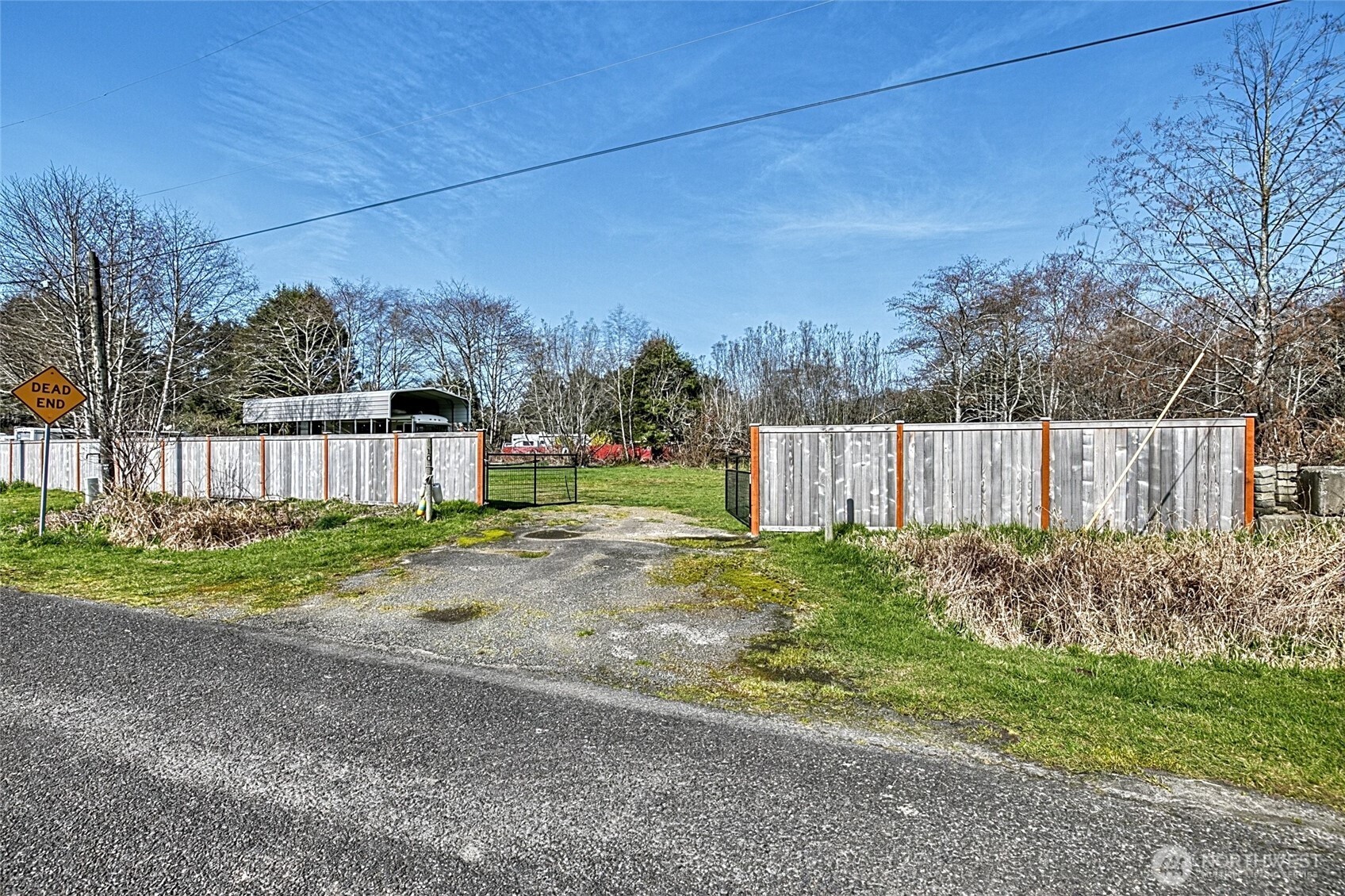 a view of a backyard with wooden fence