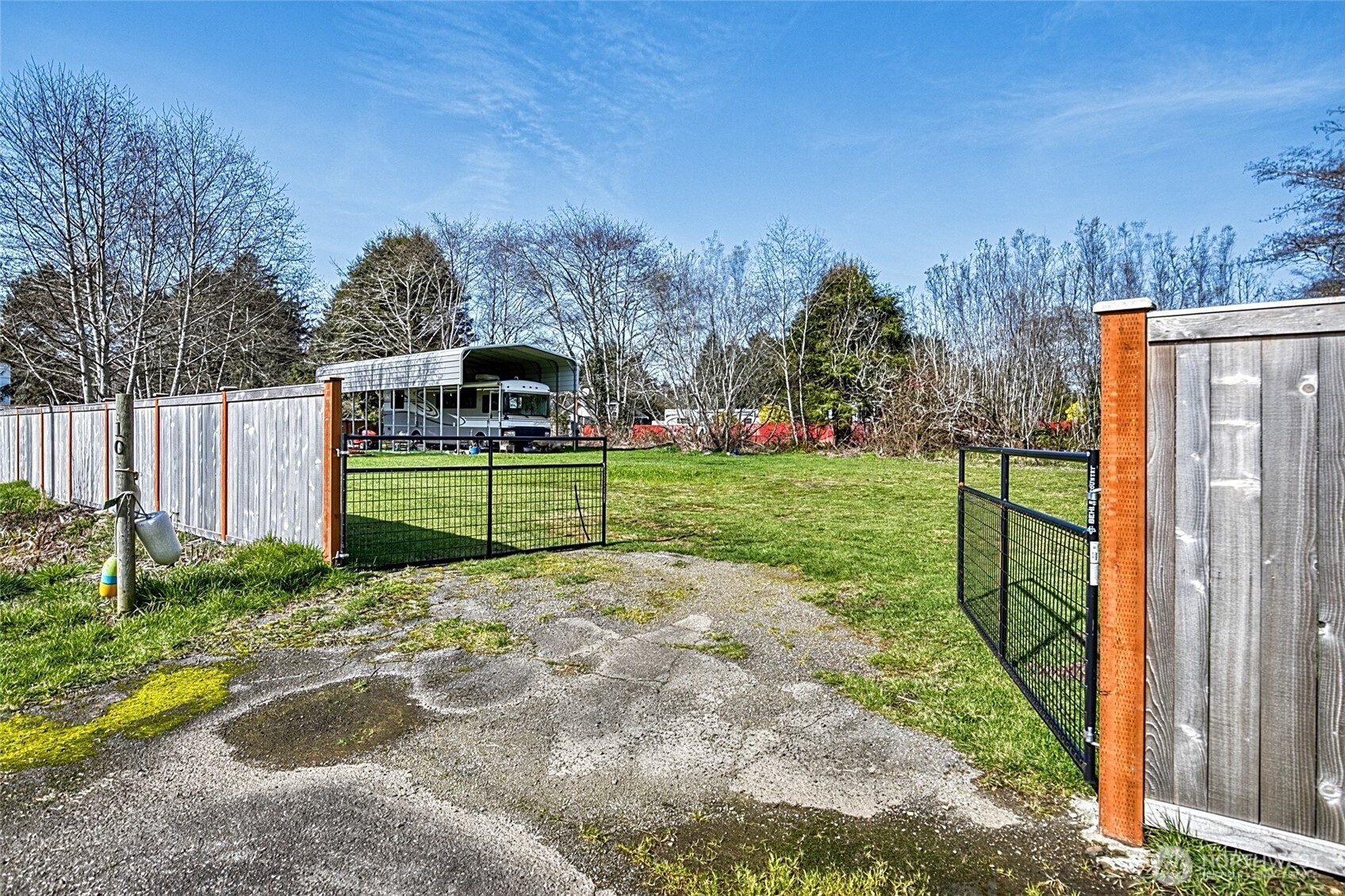 10 5th Avenue Copalis Beach, WA 98535 - Photo 2 of 13 a view of a back yard with flower plants and wooden fence