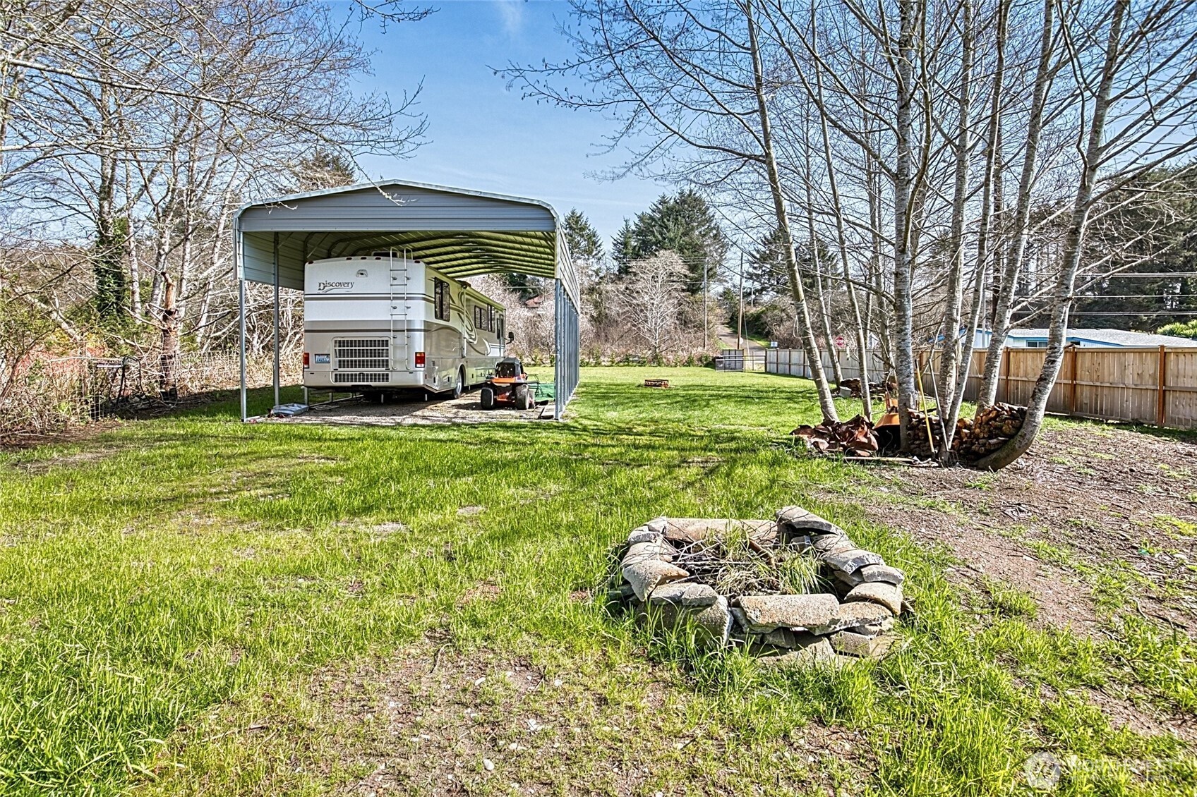 10 5th Avenue Copalis Beach, WA 98535 - Photo 3 of 13 a view of a garden with a bench and some trees