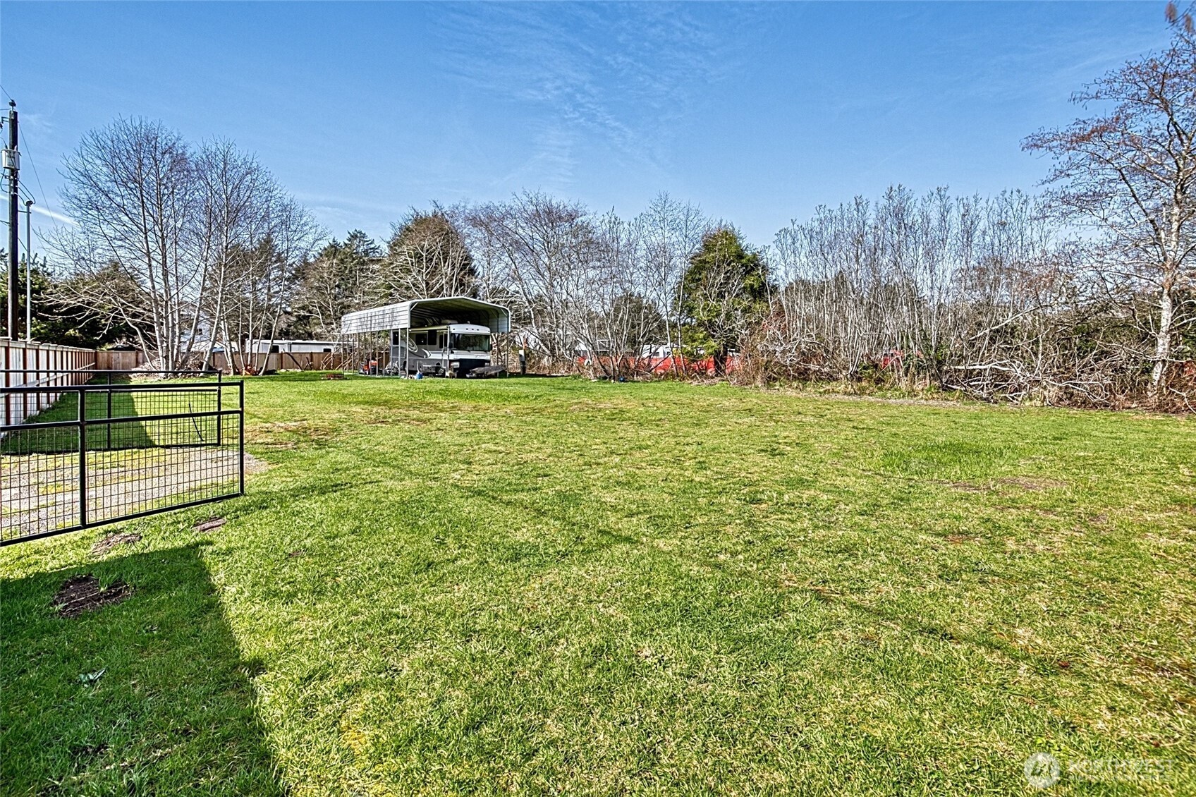10 5th Avenue Copalis Beach, WA 98535 - Photo 10 of 13 a white house with a big yard and large trees