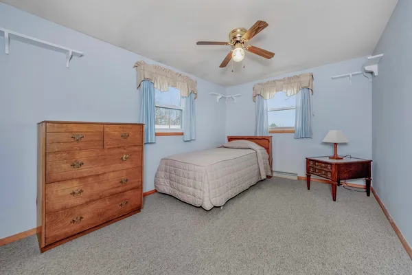 a bedroom with a bed and dresser
